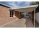 Covered carport with brick exterior wall and access to garage at 2112 W Mulberry Dr, Phoenix, AZ 85015