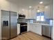 Modern kitchen with white cabinets, stainless steel appliances, and quartz countertops at 2112 W Mulberry Dr, Phoenix, AZ 85015