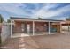 Covered patio with brick walls and two teal chairs at 2112 W Mulberry Dr, Phoenix, AZ 85015