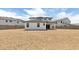 A spacious, dirt-covered backyard with a white house and block wall fence provides room for outdoor activities at 2316 W Moody Trl, Phoenix, AZ 85041