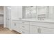 Modern bathroom featuring double sinks, marble countertops, and white cabinetry at 2316 W Moody Trl, Phoenix, AZ 85041