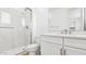 Well-lit bathroom showcasing a glass shower, toilet, and a vanity with white cabinetry at 2316 W Moody Trl, Phoenix, AZ 85041