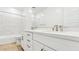 Bright bathroom featuring a double vanity, white cabinets, a tub, and a large mirror at 2316 W Moody Trl, Phoenix, AZ 85041