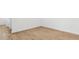 Empty room with new wood floors, baseboards, and light switches at 2316 W Moody Trl, Phoenix, AZ 85041
