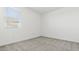 Minimalist bedroom with neutral carpeting and a window with venetian blinds and outside views at 2316 W Moody Trl, Phoenix, AZ 85041