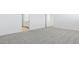 Bright bedroom with neutral carpet and white walls, with a glimpse into the bathroom at 2316 W Moody Trl, Phoenix, AZ 85041