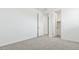 Bright bedroom featuring neutral carpet, white walls, and a closet at 2316 W Moody Trl, Phoenix, AZ 85041