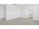 Light-filled bedroom with neutral carpeting, white walls, and an ensuite bathroom at 2316 W Moody Trl, Phoenix, AZ 85041