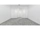 Bedroom showcasing neutral carpeting, white walls, and double doors to a closet at 2316 W Moody Trl, Phoenix, AZ 85041