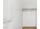 This closet has hardwood floors, a wire rack and shelf, and neutral-colored paint at 2316 W Moody Trl, Phoenix, AZ 85041