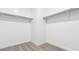 Walk-in closet with neutral carpet, white walls, and ample shelving for organized storage at 2316 W Moody Trl, Phoenix, AZ 85041