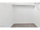 Walk-in closet with neutral carpeting, white walls, and a hanging rod for optimal storage at 2316 W Moody Trl, Phoenix, AZ 85041