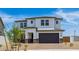 Two story home featuring a two-car garage, desert landscaping, and neutral-colored paint at 2316 W Moody Trl, Phoenix, AZ 85041