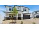 Two story home featuring a two-car garage, desert landscaping, and neutral-colored paint at 2316 W Moody Trl, Phoenix, AZ 85041