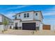 The exterior of the home features desert landscaping, a two-car garage, and neutral colors at 2316 W Moody Trl, Phoenix, AZ 85041