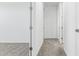 Hallway featuring neutral carpeting, doors leading to various rooms, and light-colored walls at 2316 W Moody Trl, Phoenix, AZ 85041