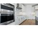 Modern kitchen features stainless steel appliances and sleek white cabinetry at 2316 W Moody Trl, Phoenix, AZ 85041