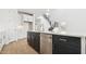 Kitchen island with stainless steel dishwasher, sink, and black cabinets at 2316 W Moody Trl, Phoenix, AZ 85041