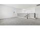 Upstairs loft with neutral carpet, white walls, and black metal banister at 2316 W Moody Trl, Phoenix, AZ 85041