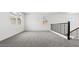 Second floor loft featuring neutral carpet, windows, and a black iron railing at 2316 W Moody Trl, Phoenix, AZ 85041