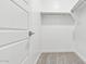 Bright walk-in closet with white walls, carpeted floor, shelves, and hanging rod at 2316 W Moody Trl, Phoenix, AZ 85041