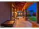 Covered patio with stone pillars, outdoor grill, and backyard view at 23414 N 84Th Pl, Scottsdale, AZ 85255