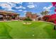 Luxury backyard oasis with putting green, pool, and expansive patio at 23414 N 84Th Pl, Scottsdale, AZ 85255