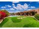 Entertain in style; this backyard boasts a putting green, pool, and expansive patio at 23414 N 84Th Pl, Scottsdale, AZ 85255