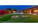 Resort-style backyard oasis with a putting green and sparkling pool at 23414 N 84Th Pl, Scottsdale, AZ 85255