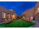 Evening view of a backyard with artificial turf and chairs at 23414 N 84Th Pl, Scottsdale, AZ 85255