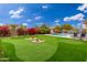 Stunning backyard featuring a putting green, pool, and relaxing patio area at 23414 N 84Th Pl, Scottsdale, AZ 85255