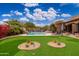 Resort-style backyard with putting green, pool, and a large patio for lounging at 23414 N 84Th Pl, Scottsdale, AZ 85255