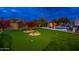 Entertain in your backyard with putting green and refreshing pool at 23414 N 84Th Pl, Scottsdale, AZ 85255