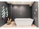 Bathroom with freestanding tub and dark walls at 23414 N 84Th Pl, Scottsdale, AZ 85255