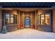 Elegant entryway with a stone facade and wrought iron door at 23414 N 84Th Pl, Scottsdale, AZ 85255