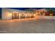 Four-car garage with wood doors and exterior lighting at 23414 N 84Th Pl, Scottsdale, AZ 85255