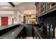 Modern home bar with dark cabinetry and a granite countertop at 23414 N 84Th Pl, Scottsdale, AZ 85255