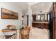 Cozy kitchen with dark wood cabinets and a glass-topped dining table at 23414 N 84Th Pl, Scottsdale, AZ 85255