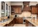 Gourmet kitchen features granite countertops, dark wood cabinetry, and high-end appliances at 23414 N 84Th Pl, Scottsdale, AZ 85255