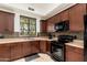 Well-equipped kitchen featuring dark wood cabinets and modern appliances at 23414 N 84Th Pl, Scottsdale, AZ 85255