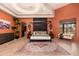 Bright main bedroom with a four-poster bed and hardwood floors at 23414 N 84Th Pl, Scottsdale, AZ 85255