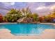 Relaxing pool with rock waterfall and slide feature at 23414 N 84Th Pl, Scottsdale, AZ 85255