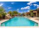 Large rectangular pool with a rock waterfall feature at 23414 N 84Th Pl, Scottsdale, AZ 85255