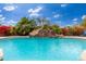 Stunning pool with a rock waterfall feature at 23414 N 84Th Pl, Scottsdale, AZ 85255