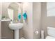 Clean bathroom with pedestal sink, toilet and decorative towels at 26015 N 53Rd Dr, Phoenix, AZ 85083