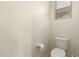 Simple bathroom with toilet and window at 26015 N 53Rd Dr, Phoenix, AZ 85083