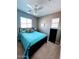 Bedroom with a teal comforter and ceiling fan at 26015 N 53Rd Dr, Phoenix, AZ 85083