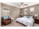 Spacious bedroom with king-size bed and ceiling fan at 26015 N 53Rd Dr, Phoenix, AZ 85083