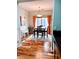 Bright dining room with wood floors and orange curtains at 26015 N 53Rd Dr, Phoenix, AZ 85083