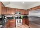 Kitchen with stainless steel appliances and dark wood cabinets at 26015 N 53Rd Dr, Phoenix, AZ 85083